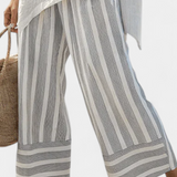 Fiorella – elegante asymmetrische blouse en gestreepte broeken